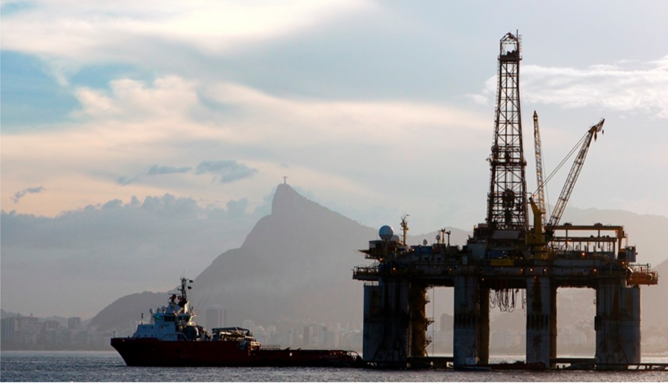 An oil rig floats past Christ the Redeemer in Brazil