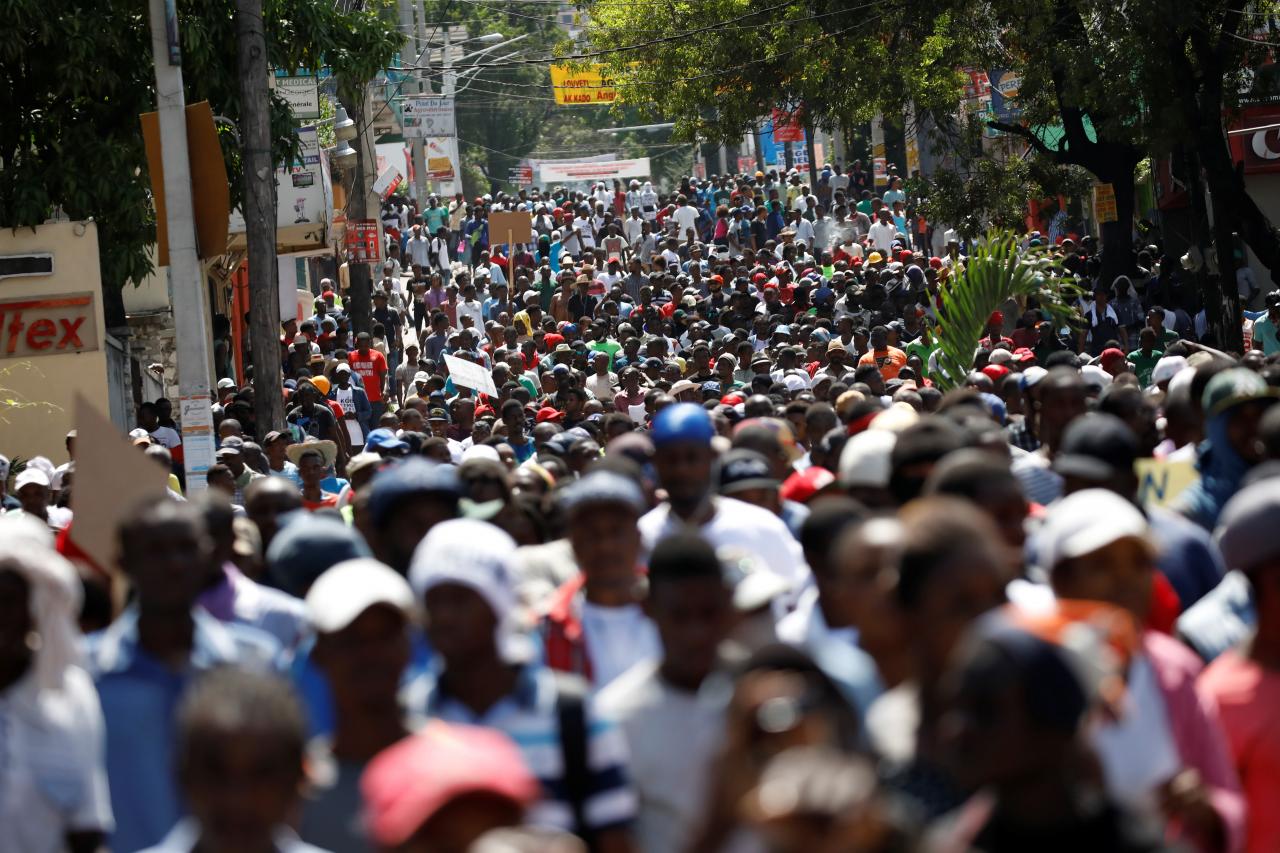 Protesters march to demand an investigation into what they say is the alleged misuse of Venezuela-sponsored PetroCaribe funds, in Port-au-Prince