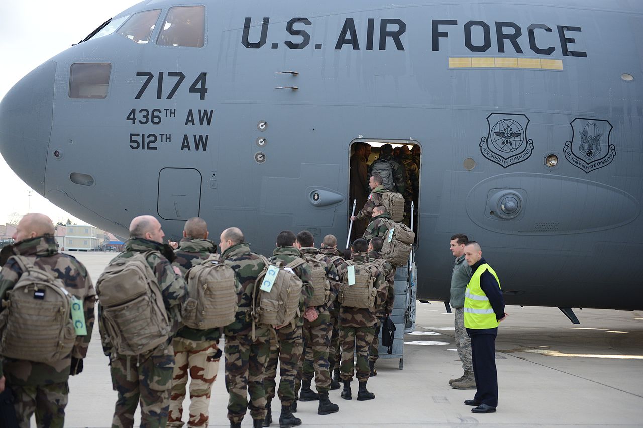 French troops board a U.S. Air Force C-17 Globemaster III cargo aircraft en route to Mali, France. The crew, out of Dover Air Force Base, Del., transported more than 80,000 pounds of equipment and over 40 French soldiers in the Air Force's first flight in support of the French military operation / Sahel G5