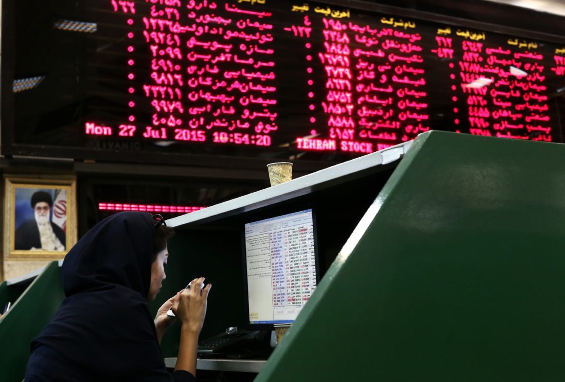 Traders watch as Iran's stock exchange plummets