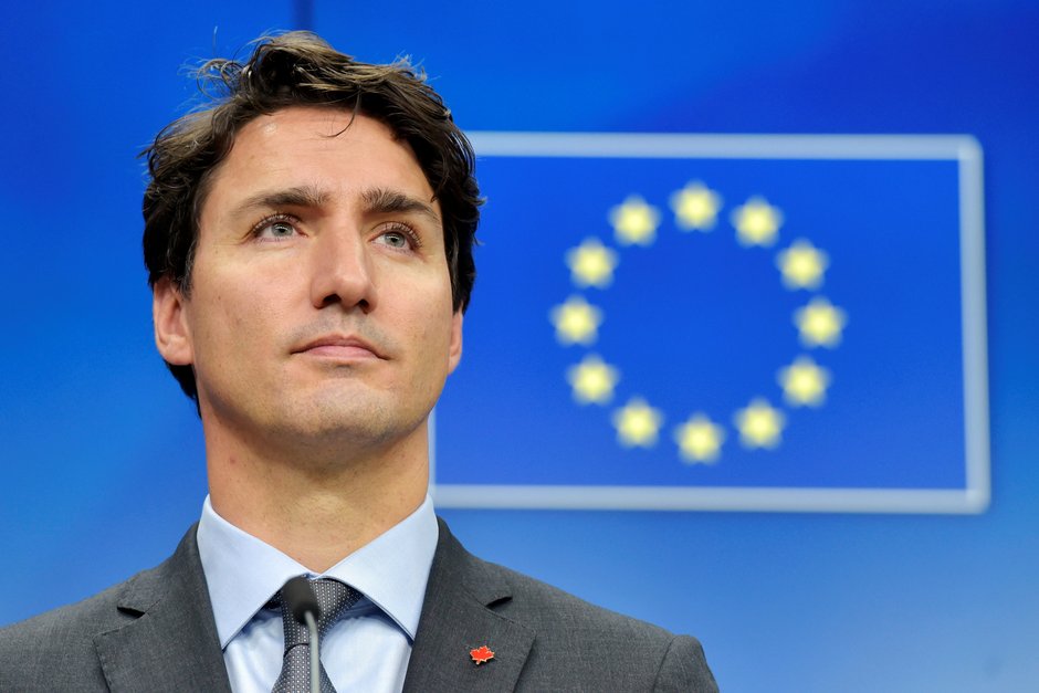 Canada’s prime minister Justin Trudeau looks on with European Union flag in background