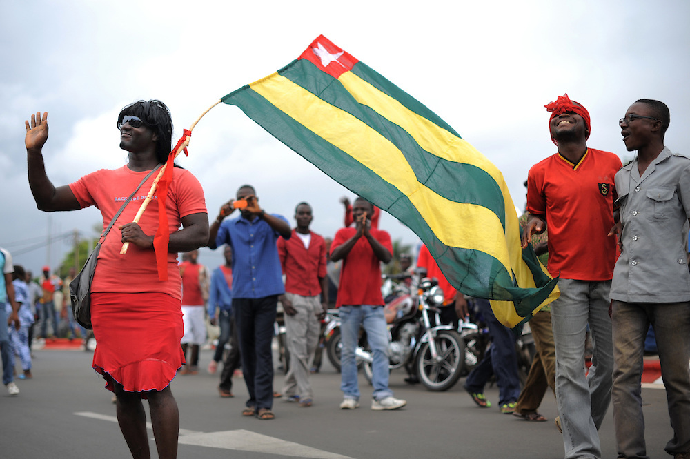 Demonstrators in Togo wave the national flag
