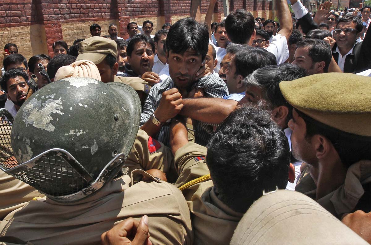 Members of the Jammu and Kashmir High Court Bar Association scuffle with Indian policemen during a protest against recent riots in Srinagar