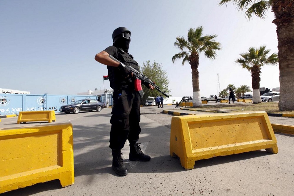 A member of the force assigned to protect Libya’s unity government stands at the entrance to where the government has their offices, in Tripoli
