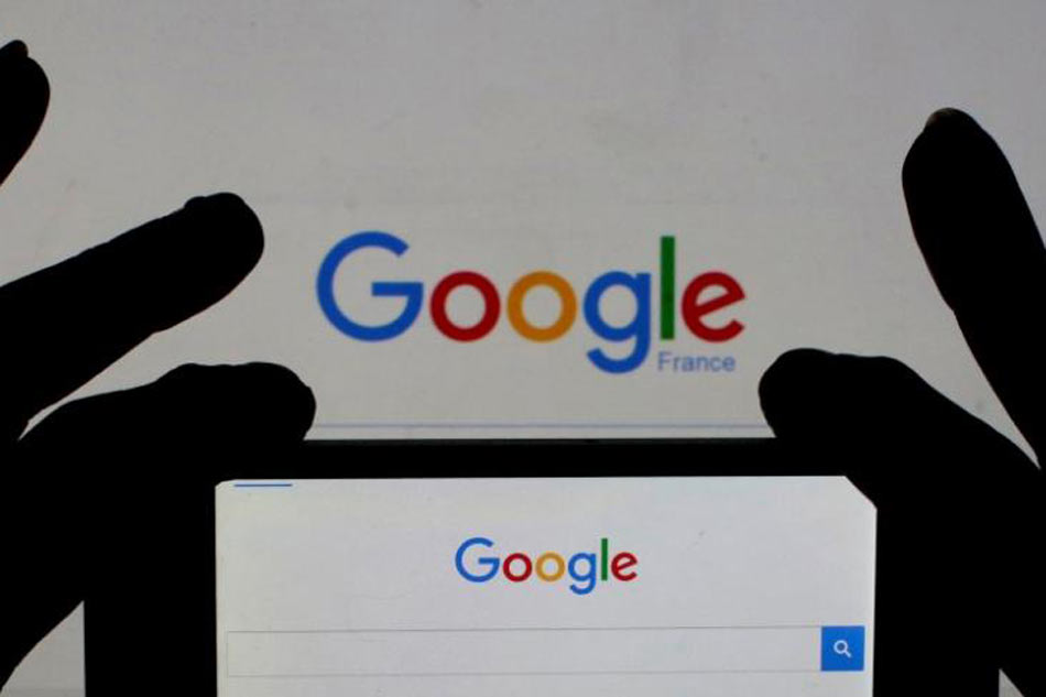 A phone taking a photo of a Google logo