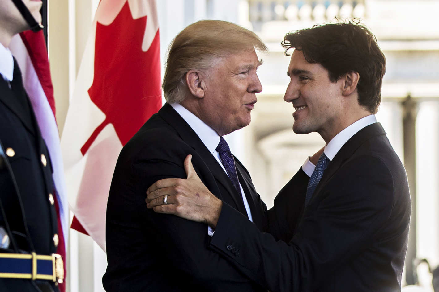 Donald Trump and Justin Trudeau embrace