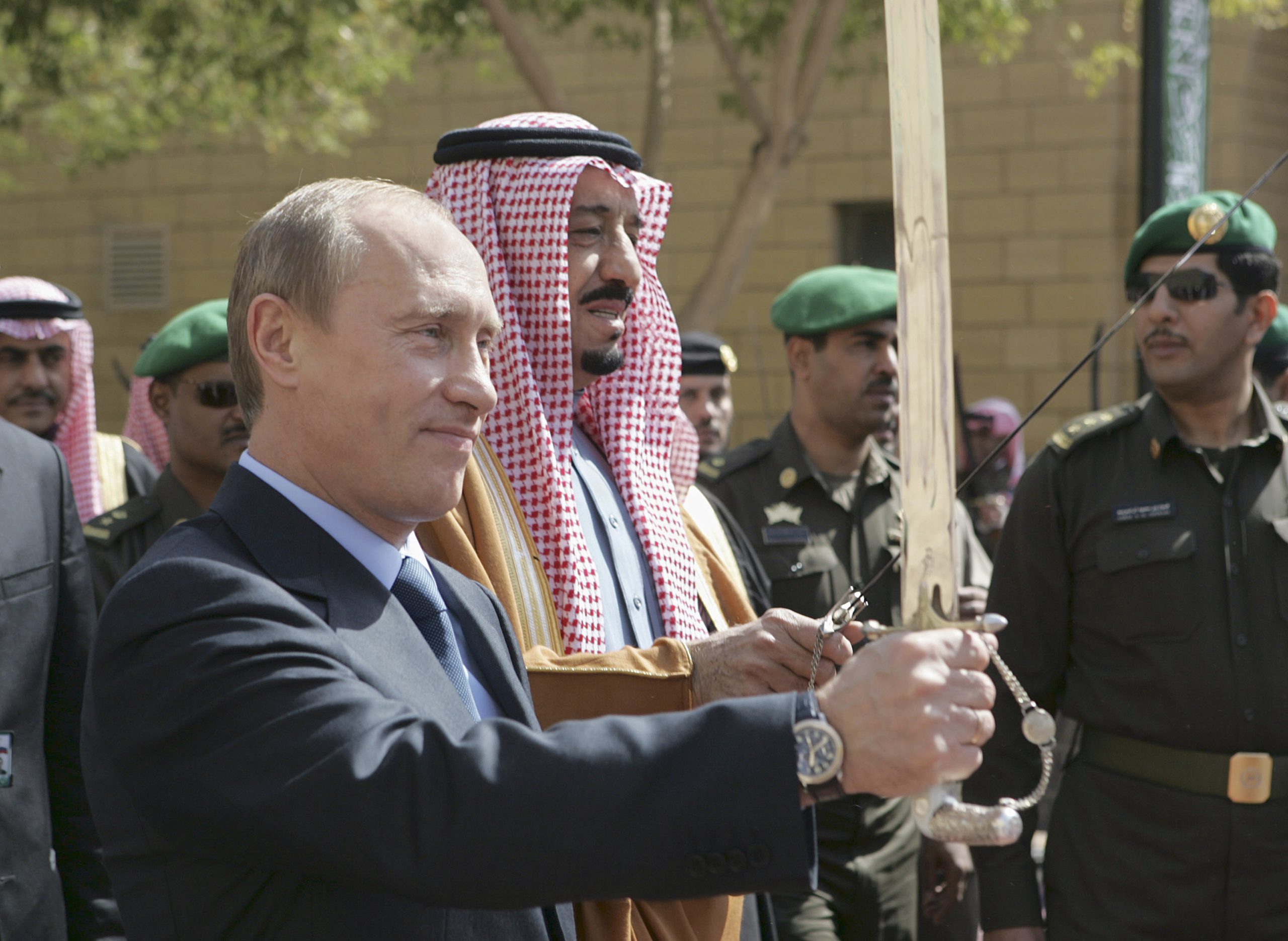 Russia’s Vladimir Putin holds an ardah along side Saudi King Salman