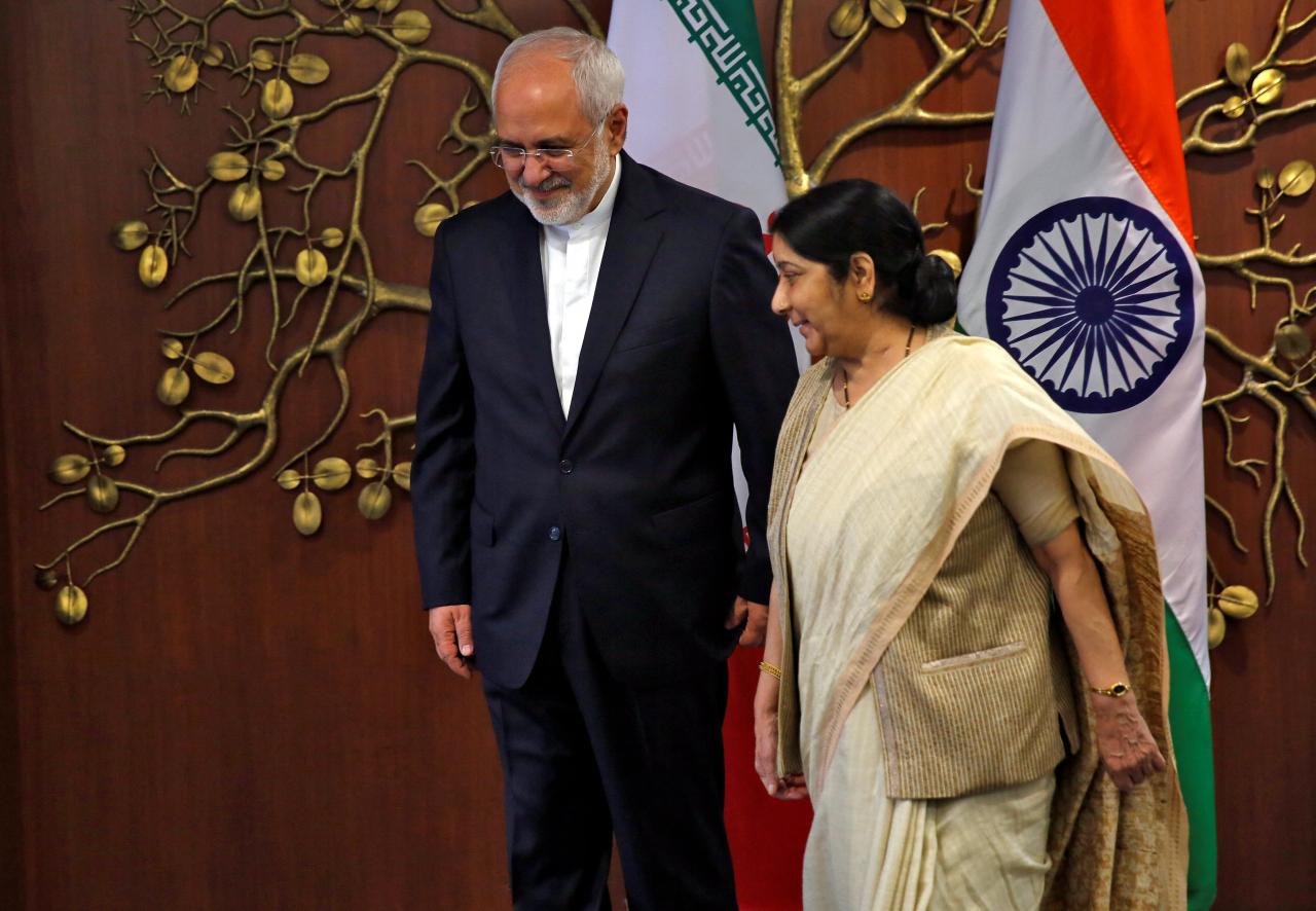 Iran’s Foreign Minister Mohammad Javad Zarif and his Indian counterpart Sushma Swaraj walk after a photo opportunity in New Delhi