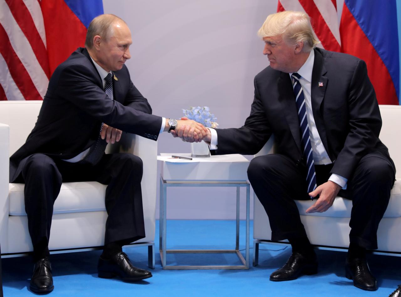 FILE PHOTO: U.S. President Donald Trump shakes hands with Russia’s President Vladimir Putin during the their bilateral meeting at the G20 summit in Hamburg