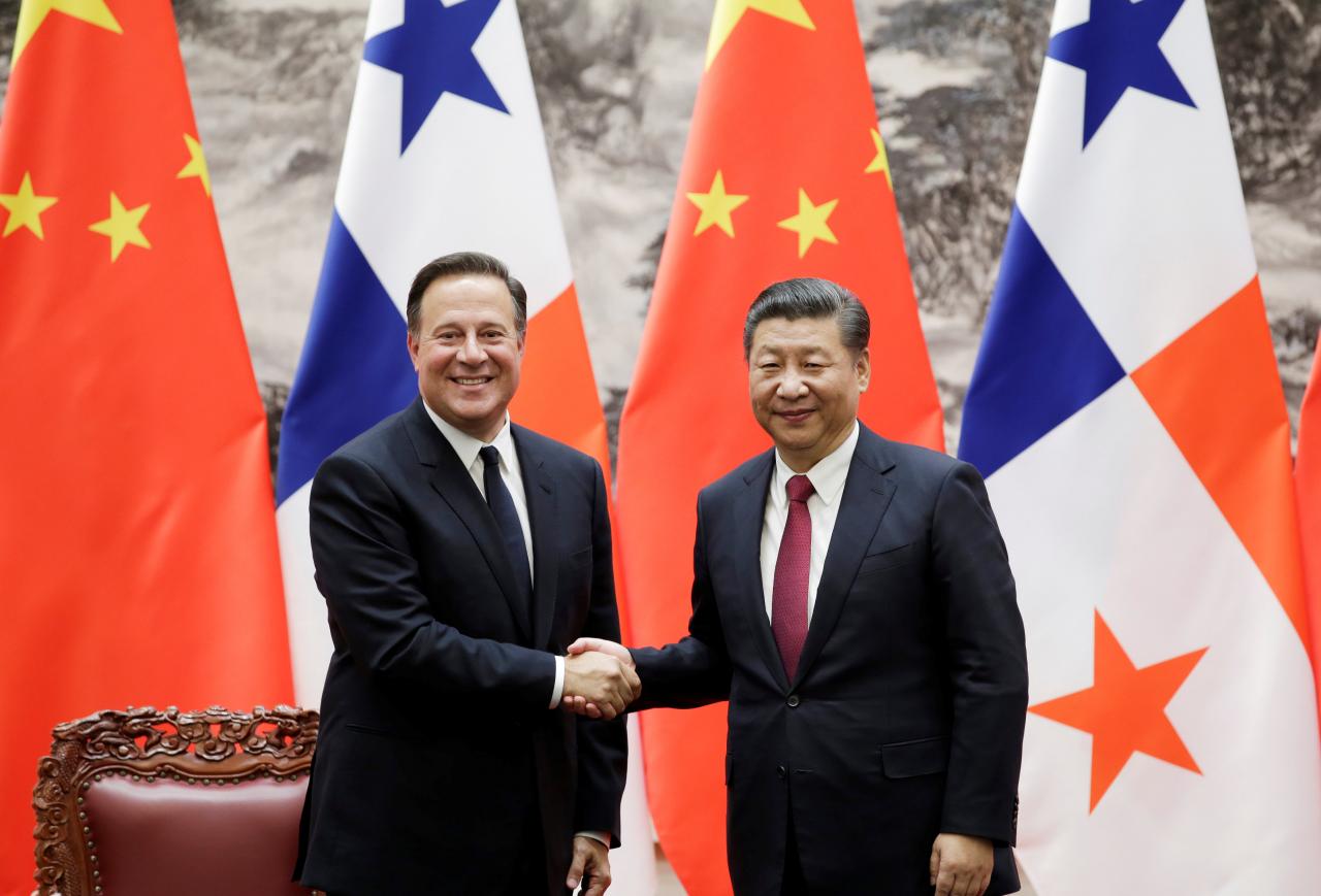 Panama’s President Juan Carlos Varela shakes hands with China’s President Xi Jinping during a signing ceremony in Beijing