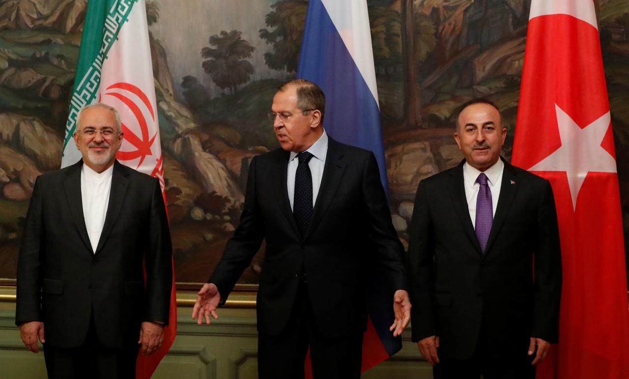 Foreign Ministers Zarif of Iran, Lavrov of Russia and Cavusoglu of Turkey gather for a family photo following their meeting in Moscow