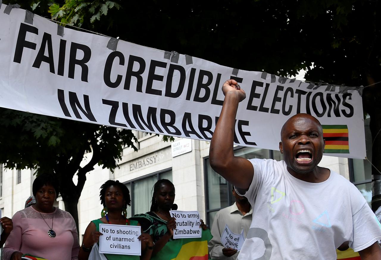 Activists and demonstrators protest following election results in Zimbabwe, outside the Zimbabwe embassy in London
