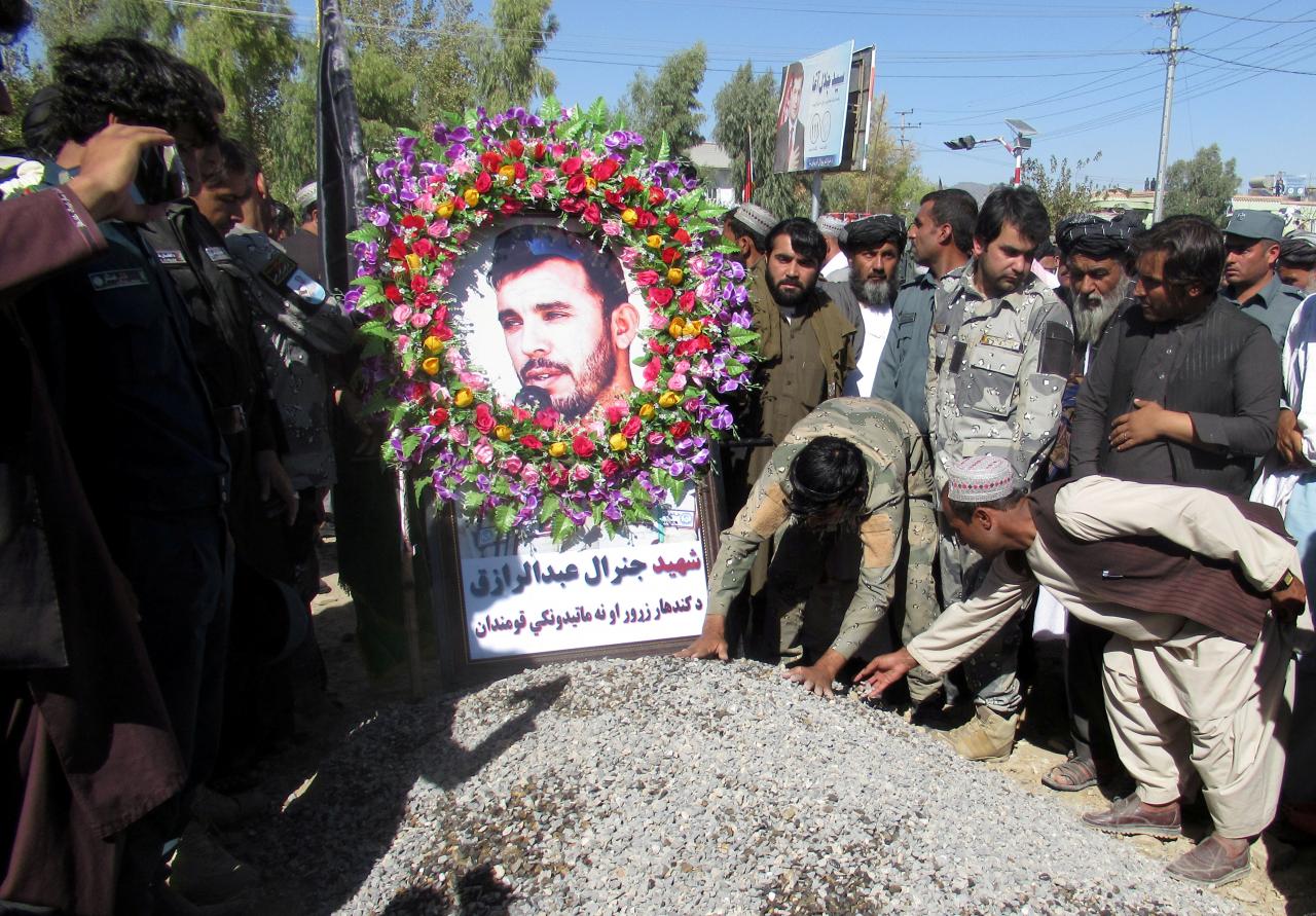 FILE PHOTO: People attend a burial ceremony of General Abdul Razeq, the Kandahar police commander, who was killed in an attack, in Kandahar province