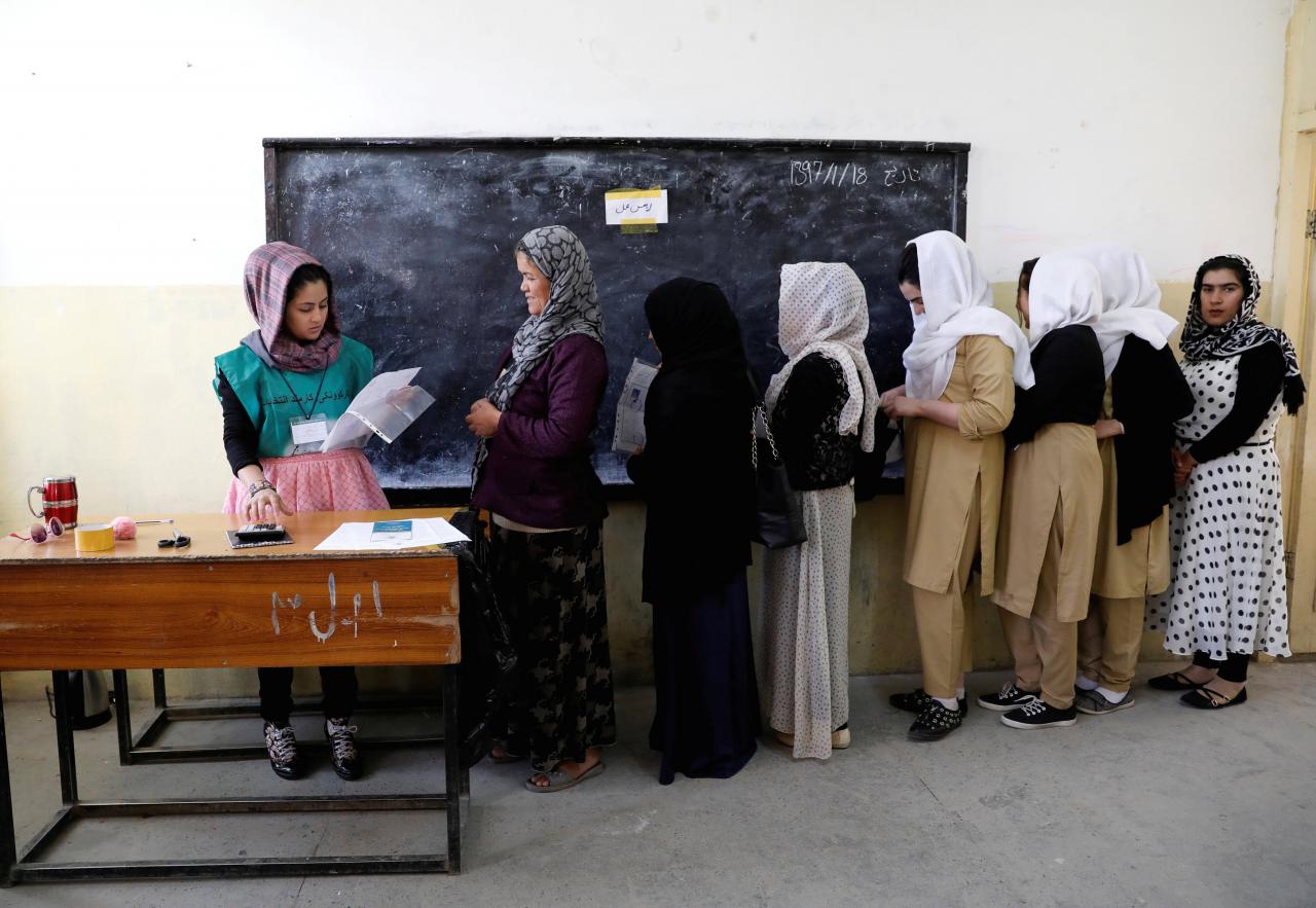 Afghan women arrive at a voter registration centre to register for the upcoming parliamentary and district council elections in Kabul