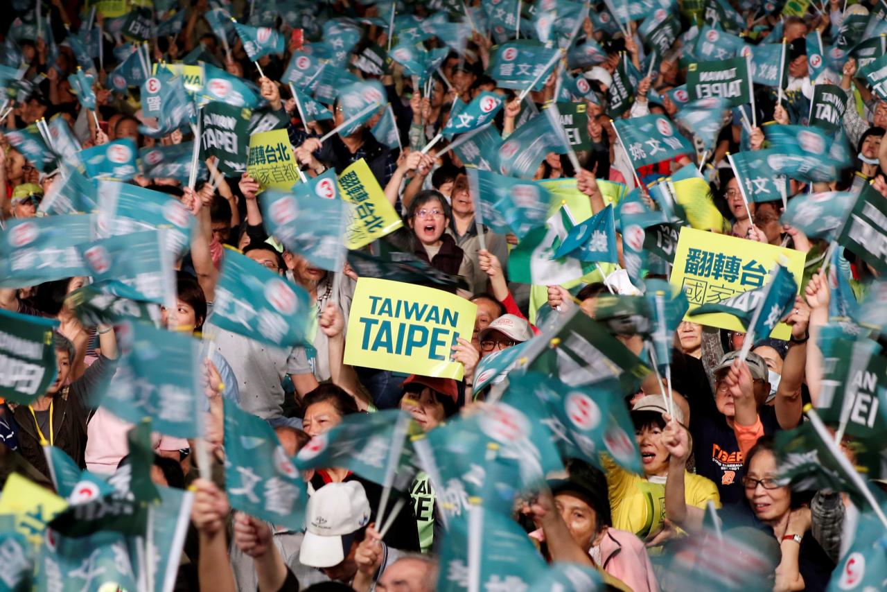 Supporters of the ruling Democratic Progressive Party (DPP) wave to candidates during a campaign rally for the local elections, in Taipei