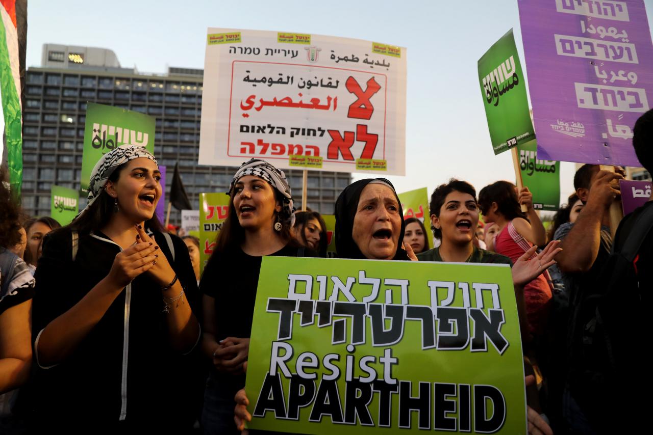 Israeli Arabs and their supporters take part in a rally to protest against Jewish nation-state law in Rabin square in Tel Aviv