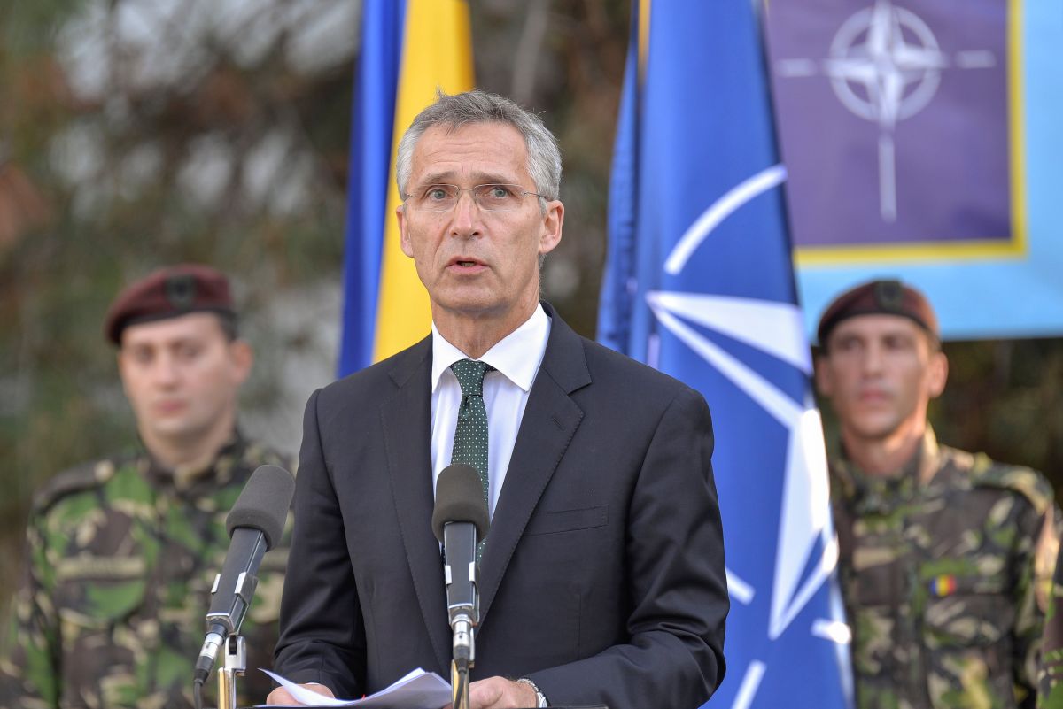 NATO Secretary-General Jens Stoltenberg delivers a speech as he reviews NATO multinational brigade in Craiova