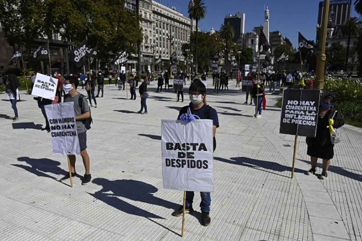 Argentinians protest the countrys rising unemployment with signs saying 22Enough layoffs22
